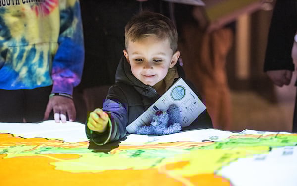 Child exploring Top Map at Watershed Stewardship Center