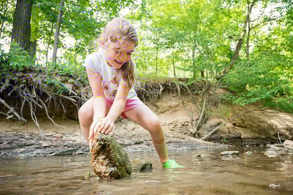 Young Girl Lifting a Rock at West Creek Reservation