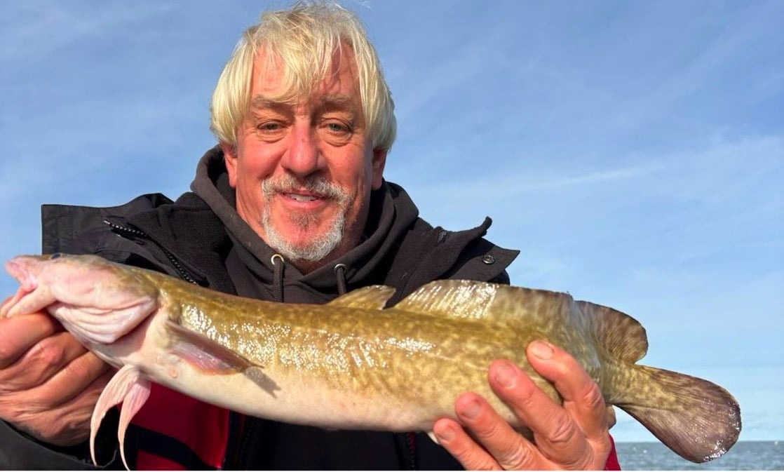 Photo of man holding yellow perch