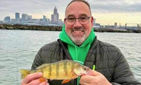 MAn holding yellow perch fish on Lake Erie