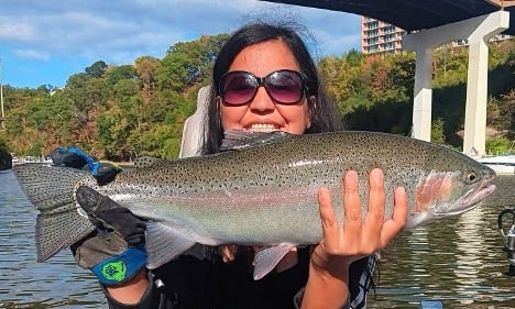 woman holding large steelhead fish