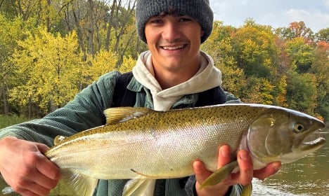 Man holding steelhead fish