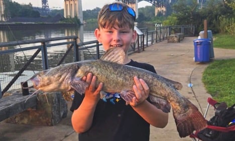 Chid holding a fish
