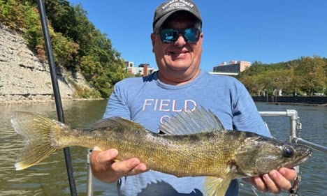 Male Volunteer Holding Large Fish