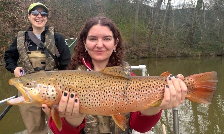 Photo of two women holding trophy sized brown trout