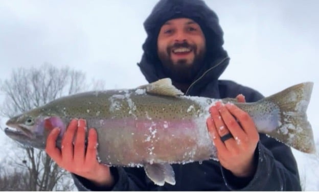 Man holding steelhead fish