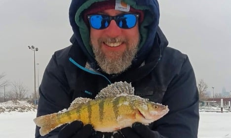 Man holding panfish near Lake Erie