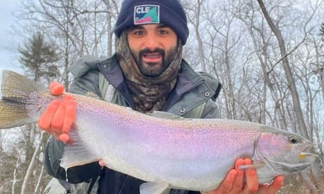 Man holding hen steelhead