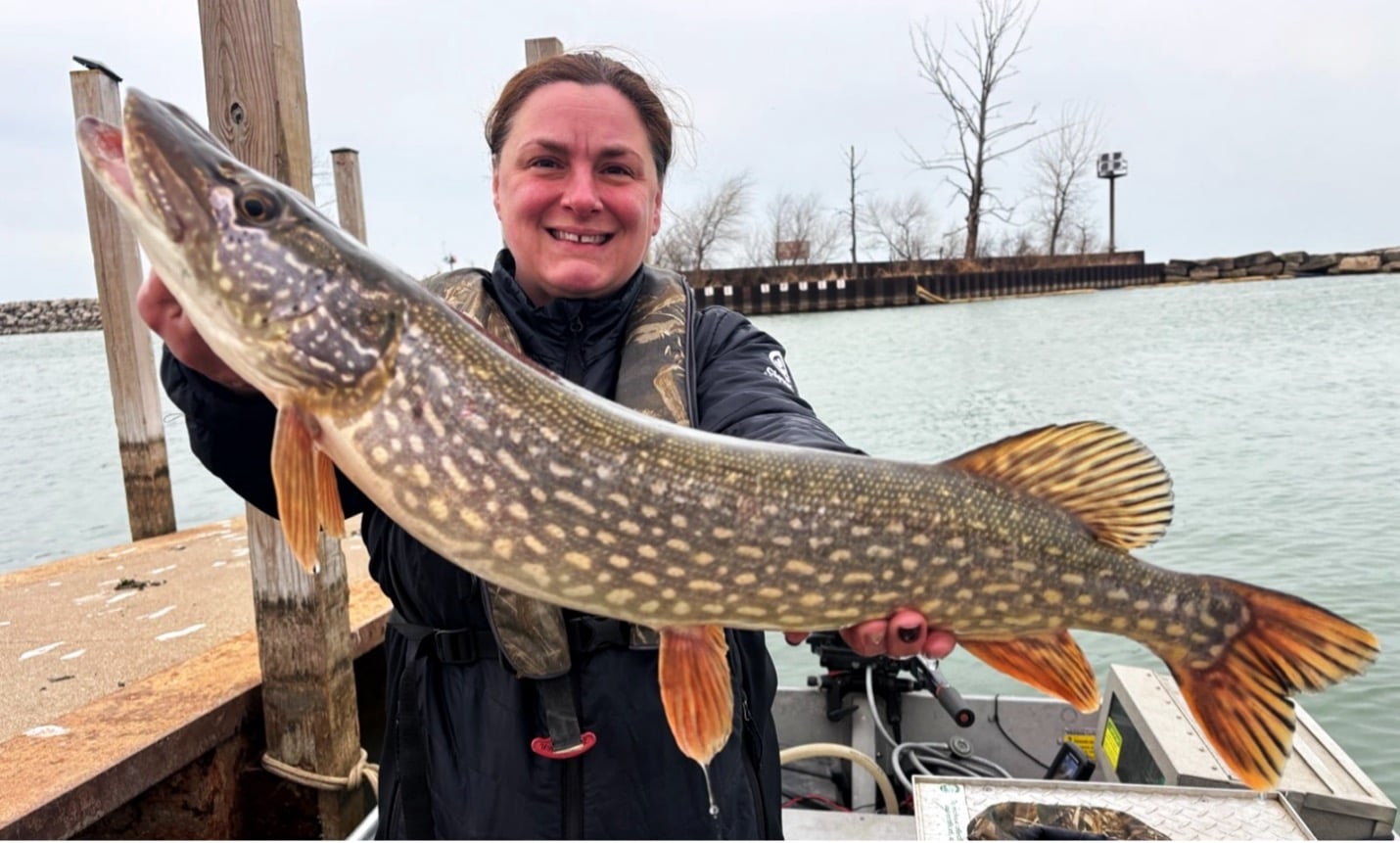 Photo of woman holding large northern pike