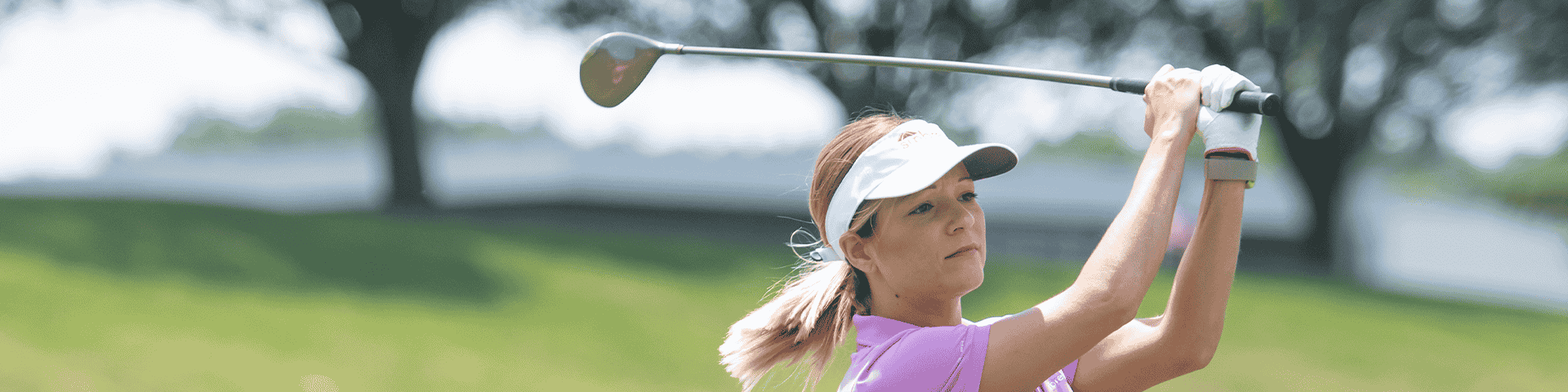 Female golfer swinging the club