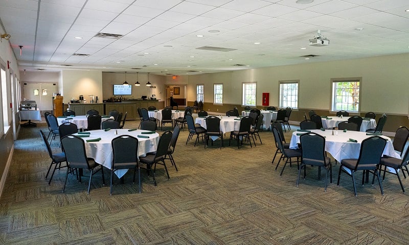 Event space with tables, chairs, and a bar