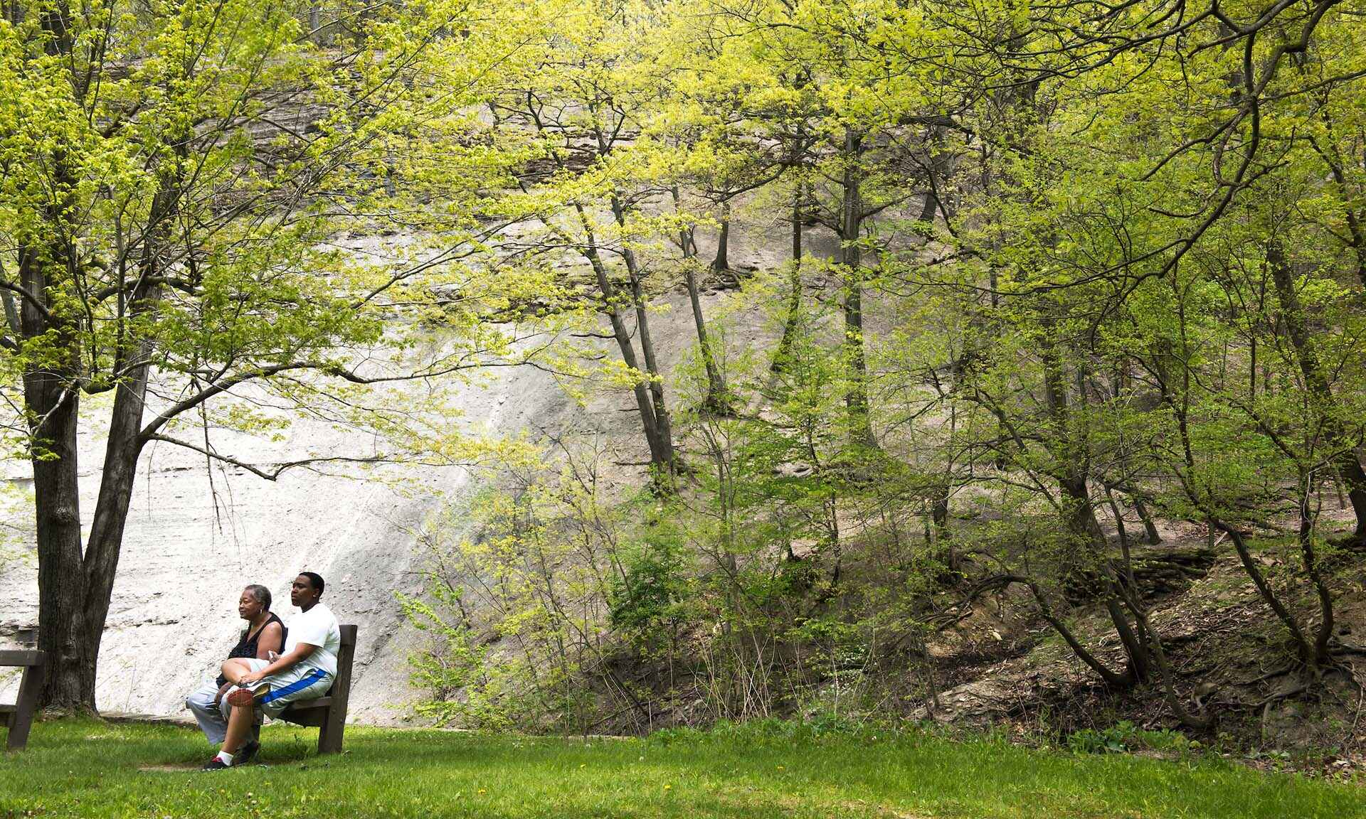 Two people sitting on bench in the park