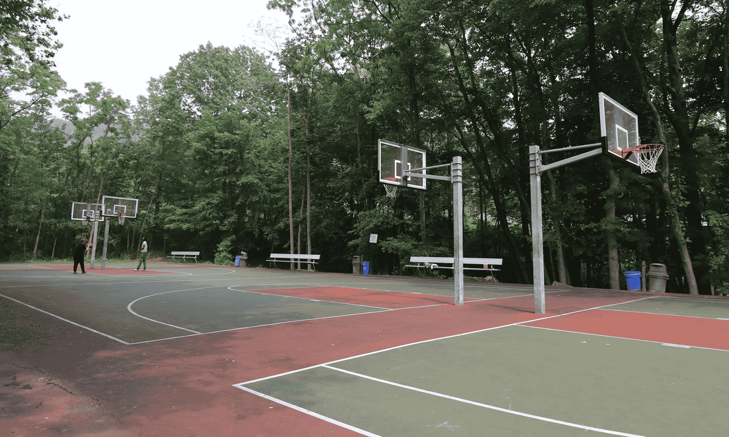 Two people playing basketball on the court