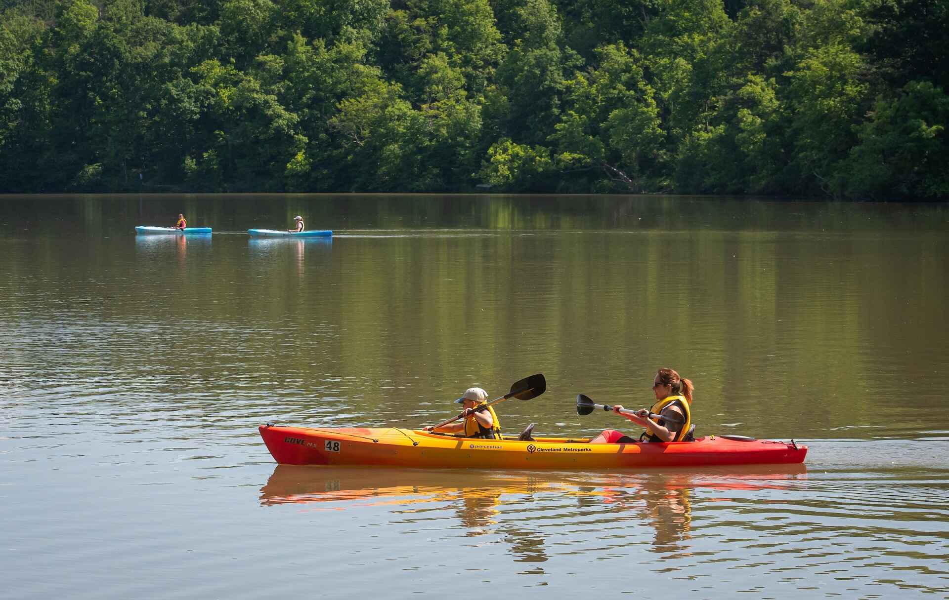 Two people kayaking on a lake