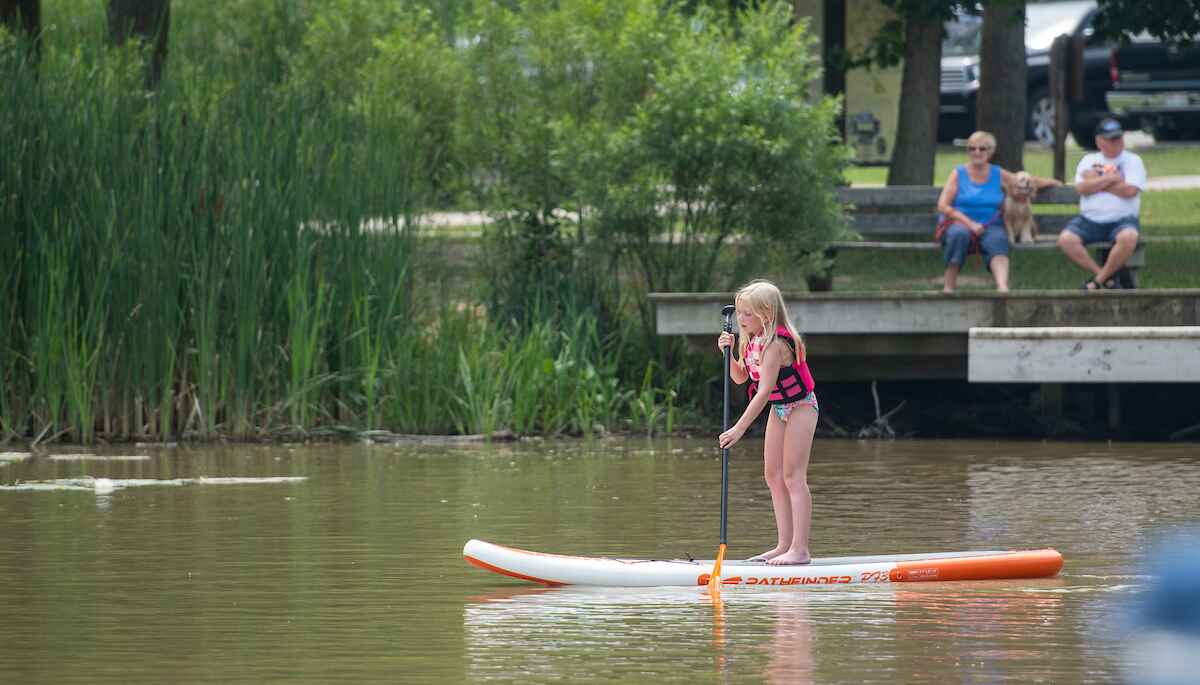 A child paddelboarding on a lake