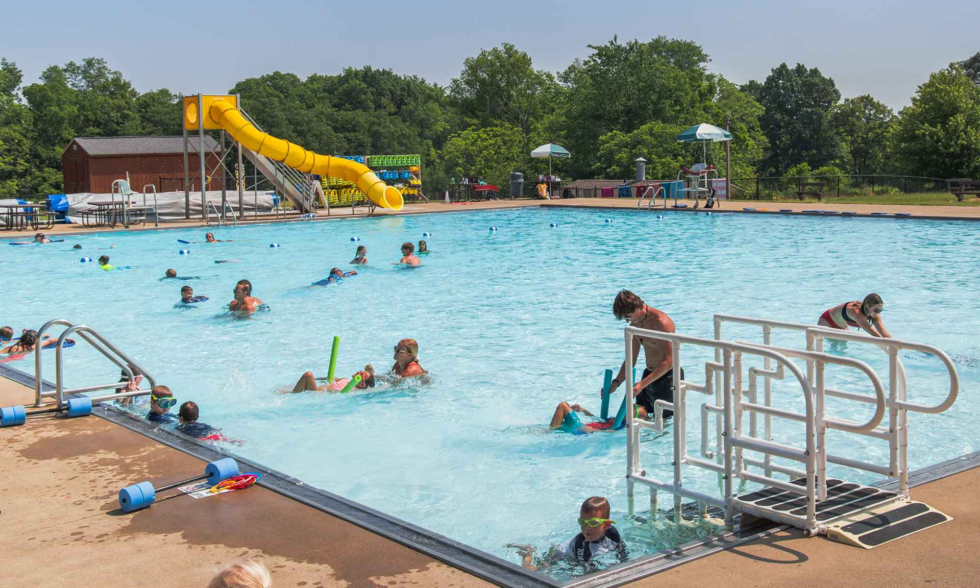 Lifeguards in a pool working on lessons with kids