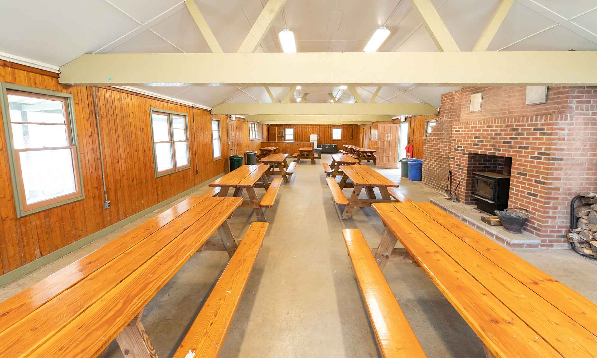 Inside of cabin with fireplace and picnic tables