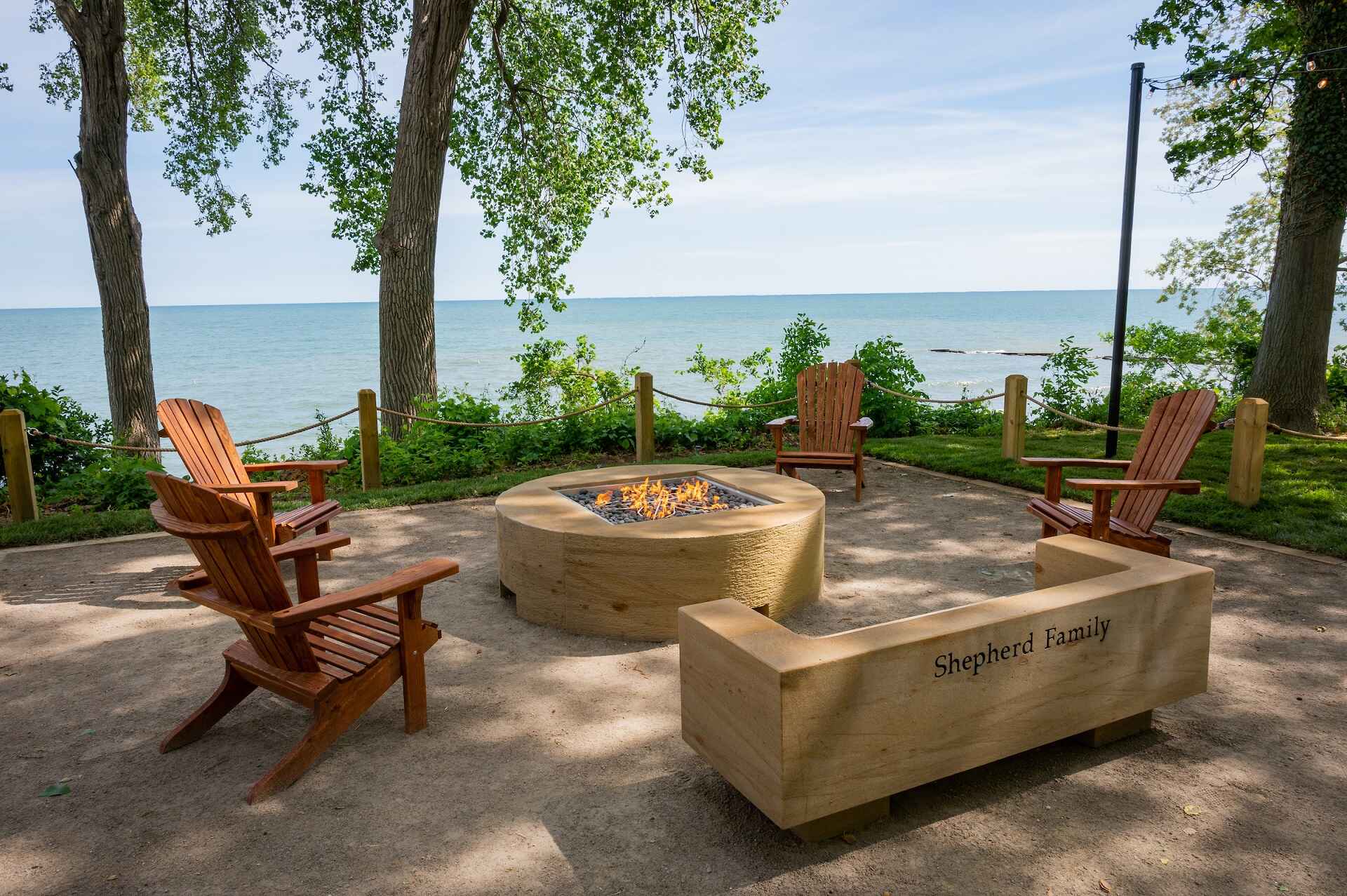 Firepit and chairs near the lake