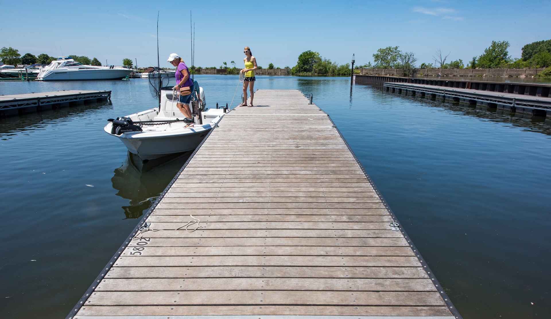 People parking their boat on the pier