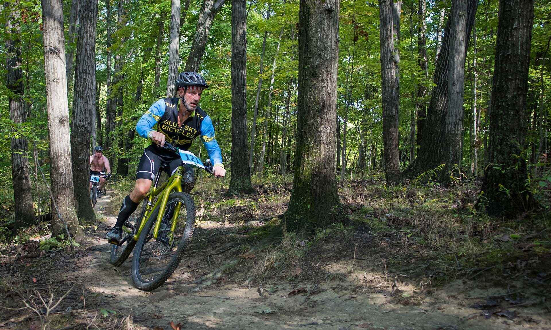 A man biking through the trees