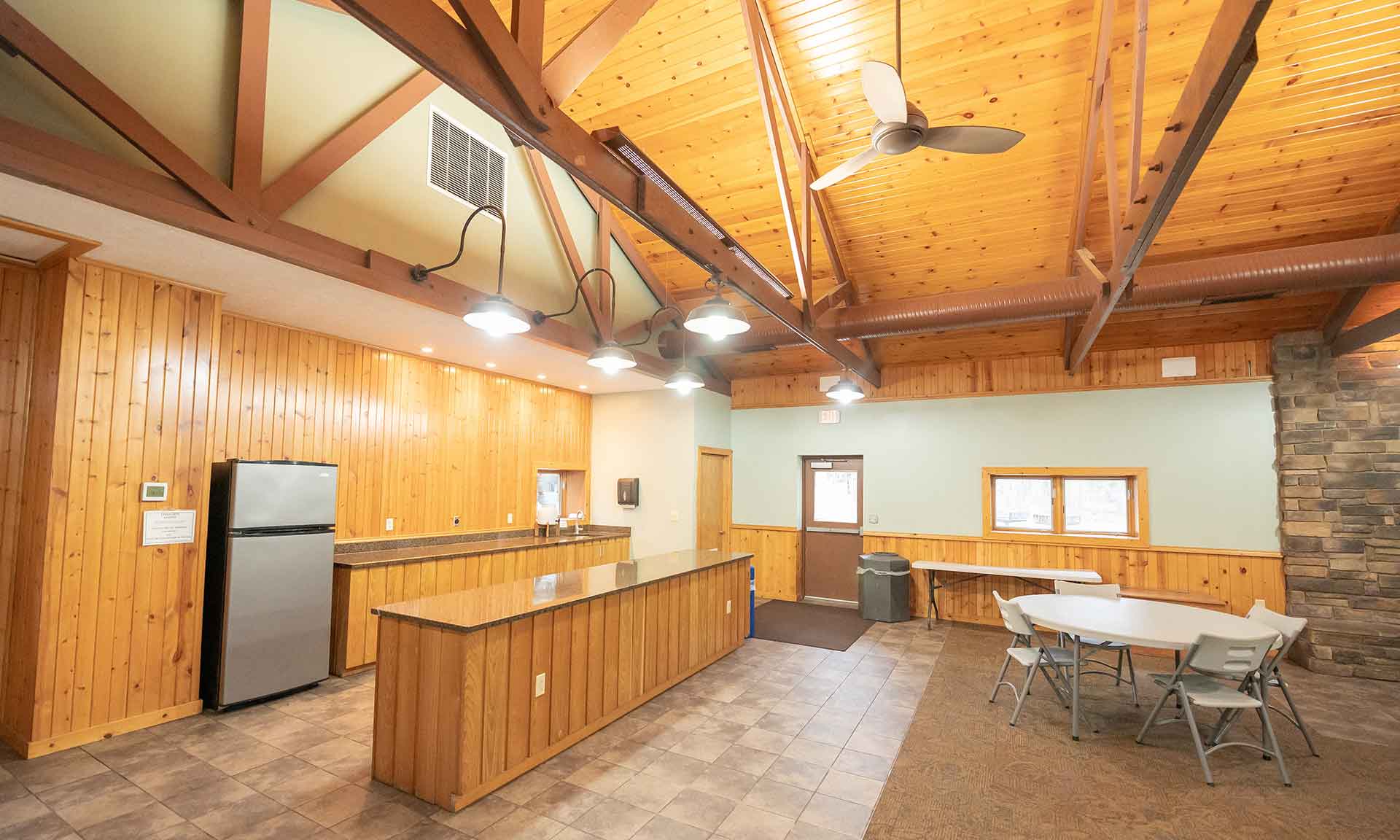 An event room with tables, a counter, and a refrigerator 