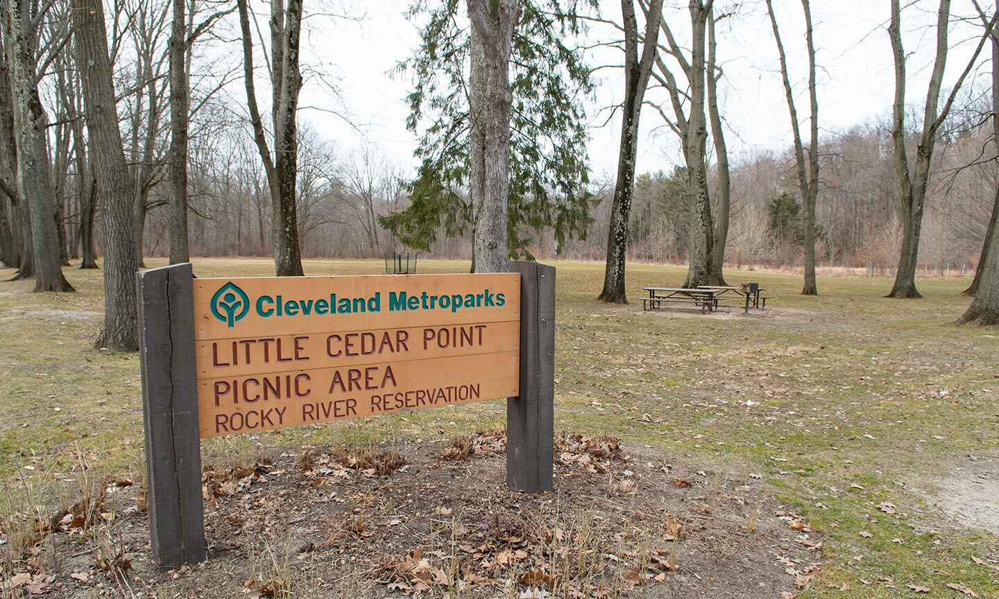 A sign in front of a picnic area
