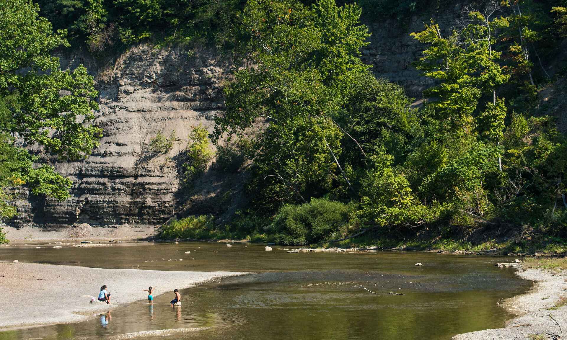 Kids playing in water with mom overseeing them