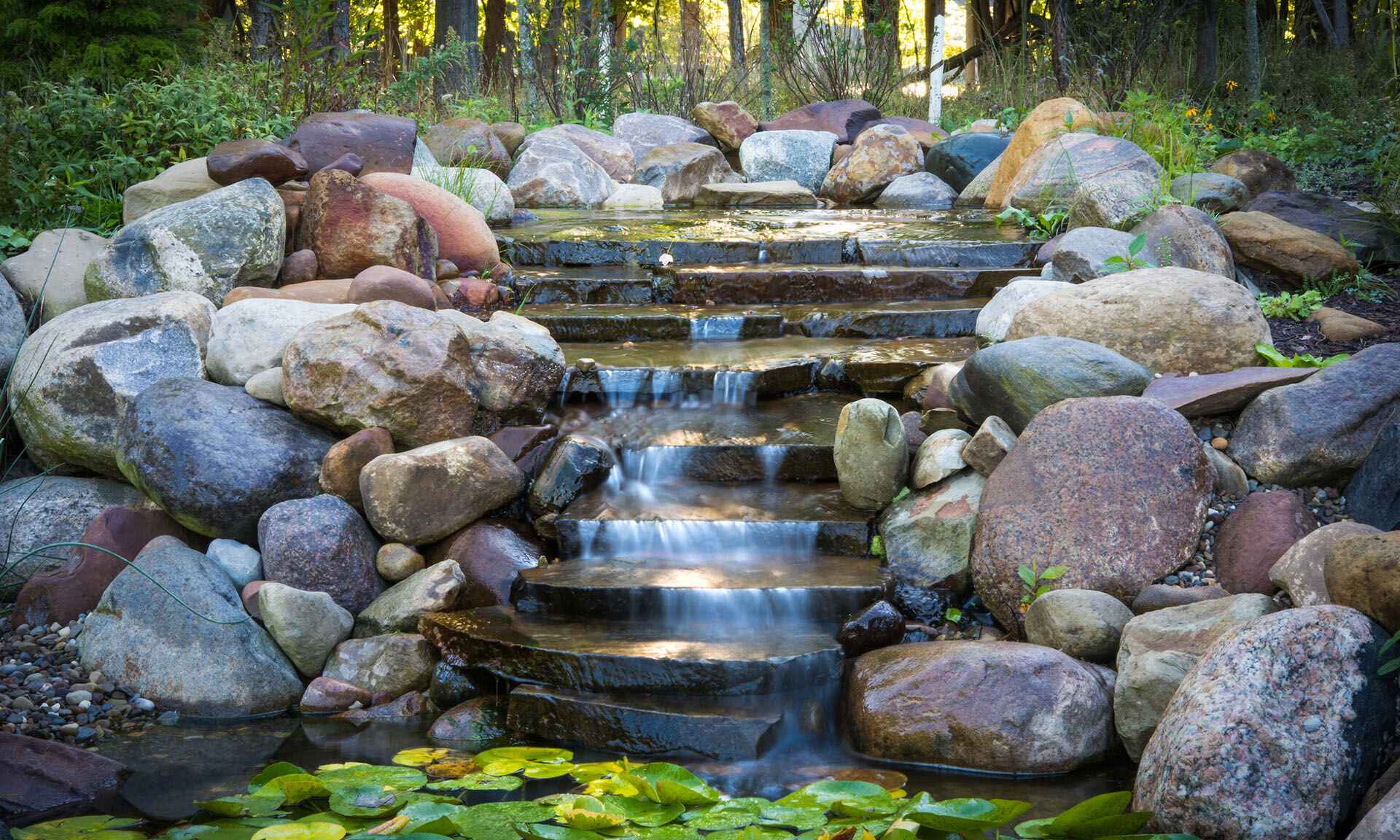 Water flowing down steps and rocks