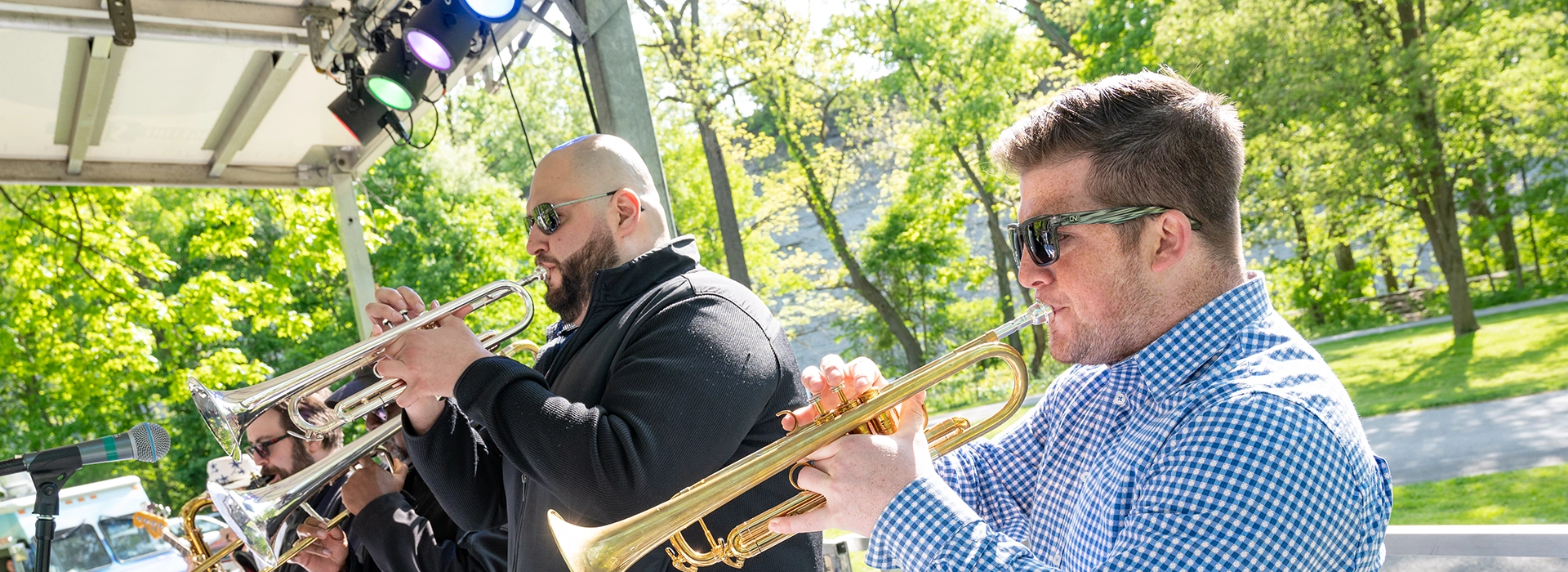 group of men playing trumpets at a concert