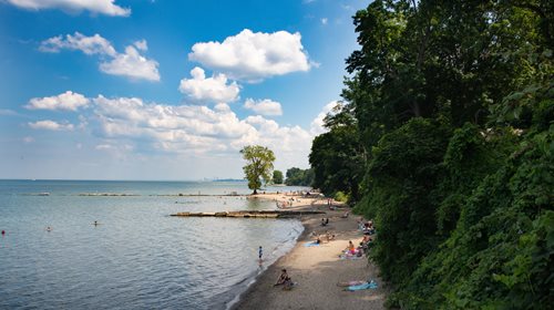 arafed view of a beach with people on it and a body of water, a stock photo inspired by Walter Beach Humphrey, shutterstock contest winner, regionalism, ohio, beach on the outer rim, beach scene